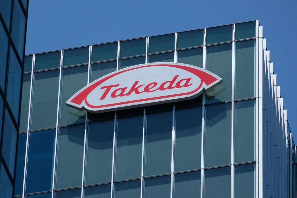 Takeda's headquarters with a forward-moving arrow symbolizing progress
