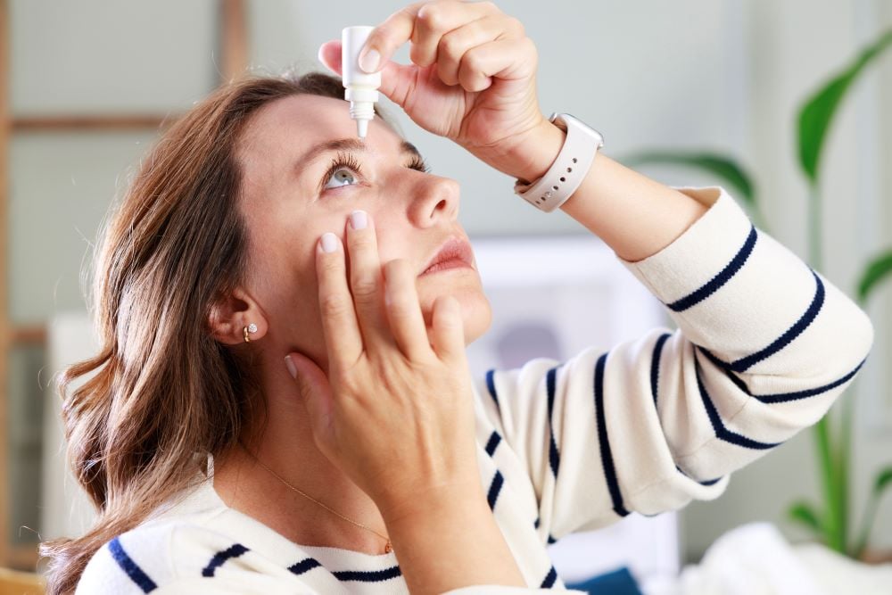 An abstract image of a droplet symbolizing eye drops over a stylized eye