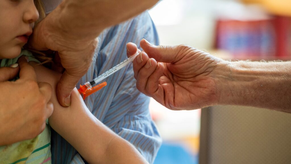 Child receiving vaccination in a clinic setting