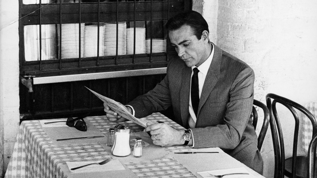A serene evening meal setting with a clock showing early dinner time, representing healthy eating habits