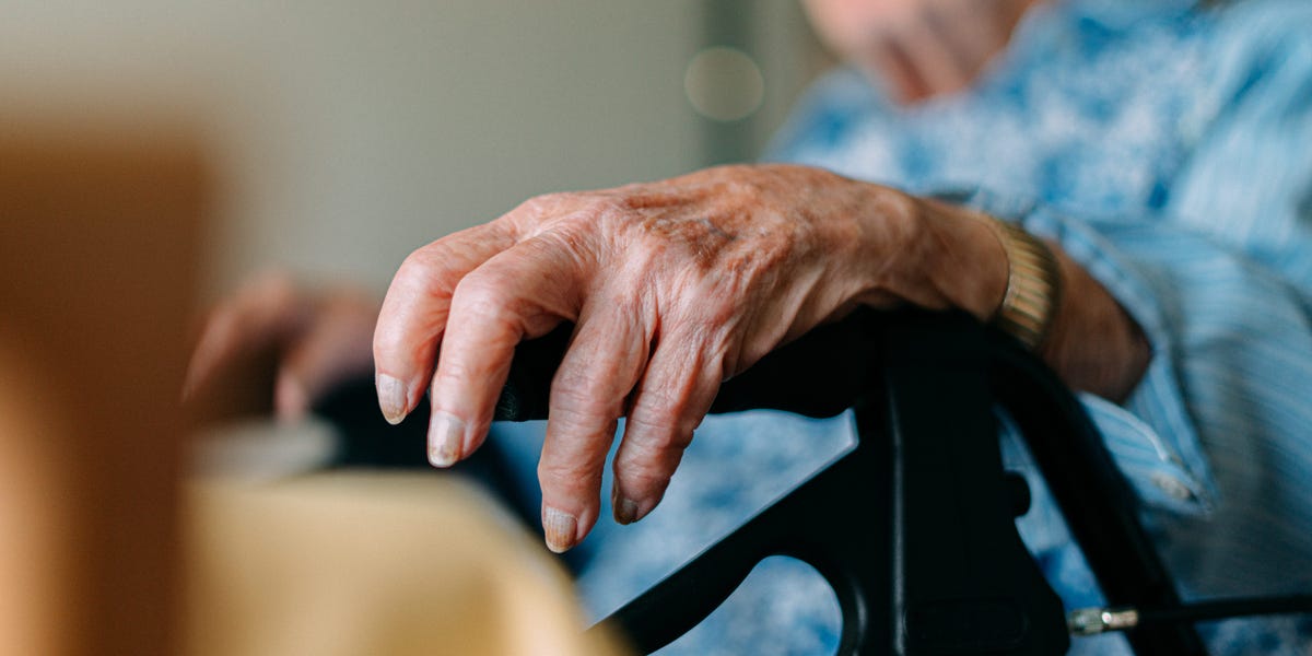 An image of a serene elderly woman enjoying nature