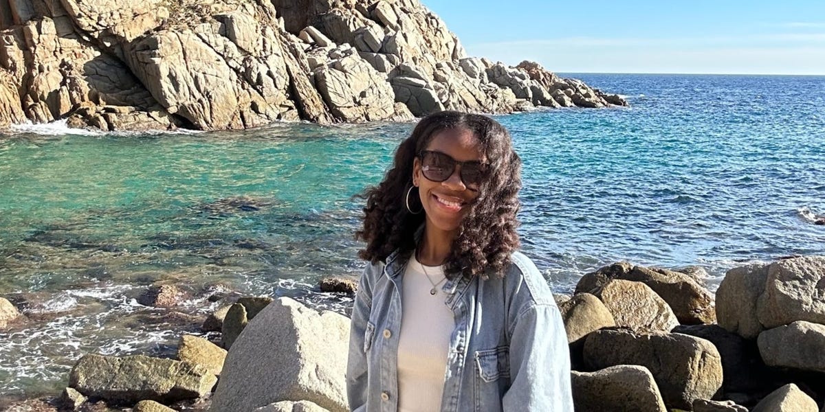 Sunrise over a serene Spanish village nestled between rolling hills and the Mediterranean Sea