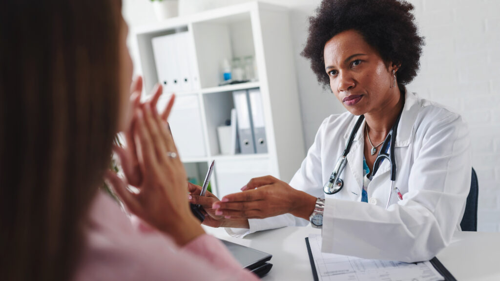Illustration of a doctor looking puzzled over patient charts