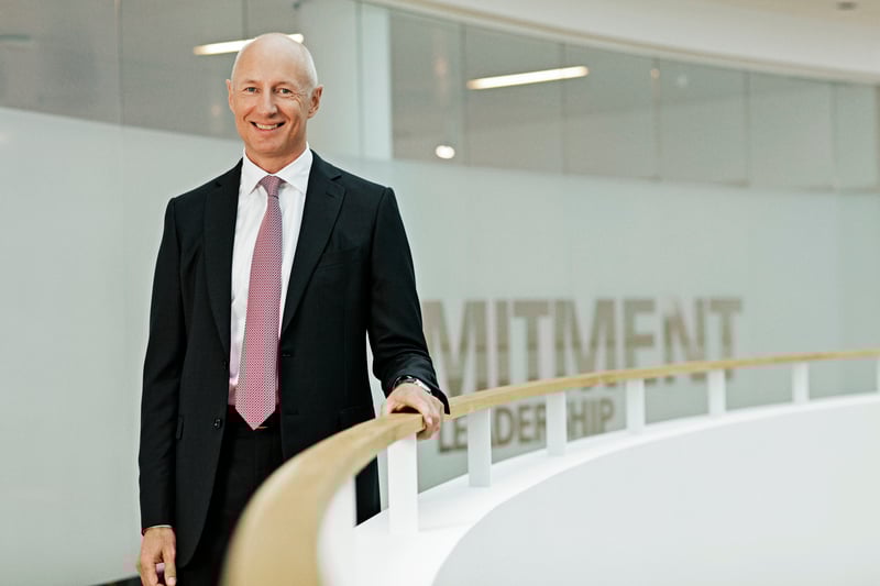 Silhouette of an executive stepping down from a skyscraper as new leadership steps up