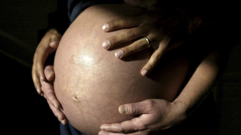 An expectant mother having her blood drawn during prenatal care