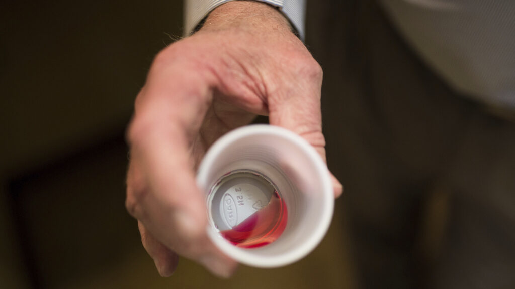 A healthcare professional preparing methadone doses
