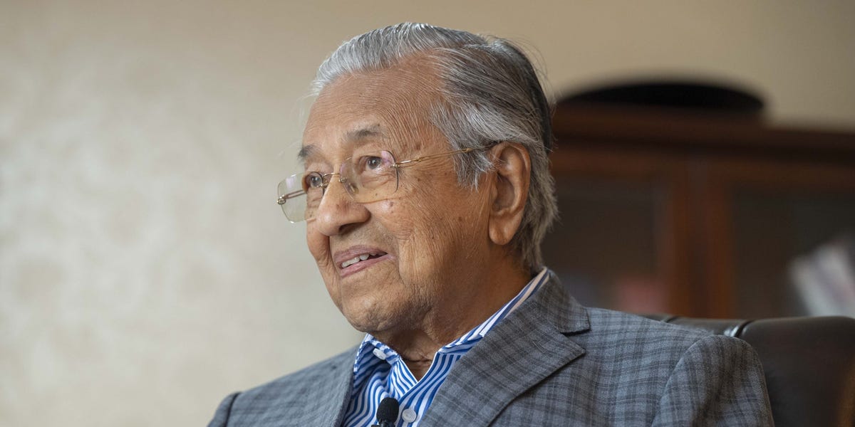 A wise elder reflecting under a serene sky.