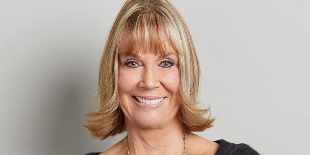 A vibrant, energetic 80-year-old woman dancing joyfully in a studio
