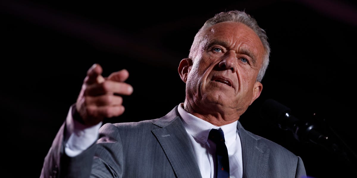 A fit 70-year-old man working out in jeans and hiking boots in a luxury gym
