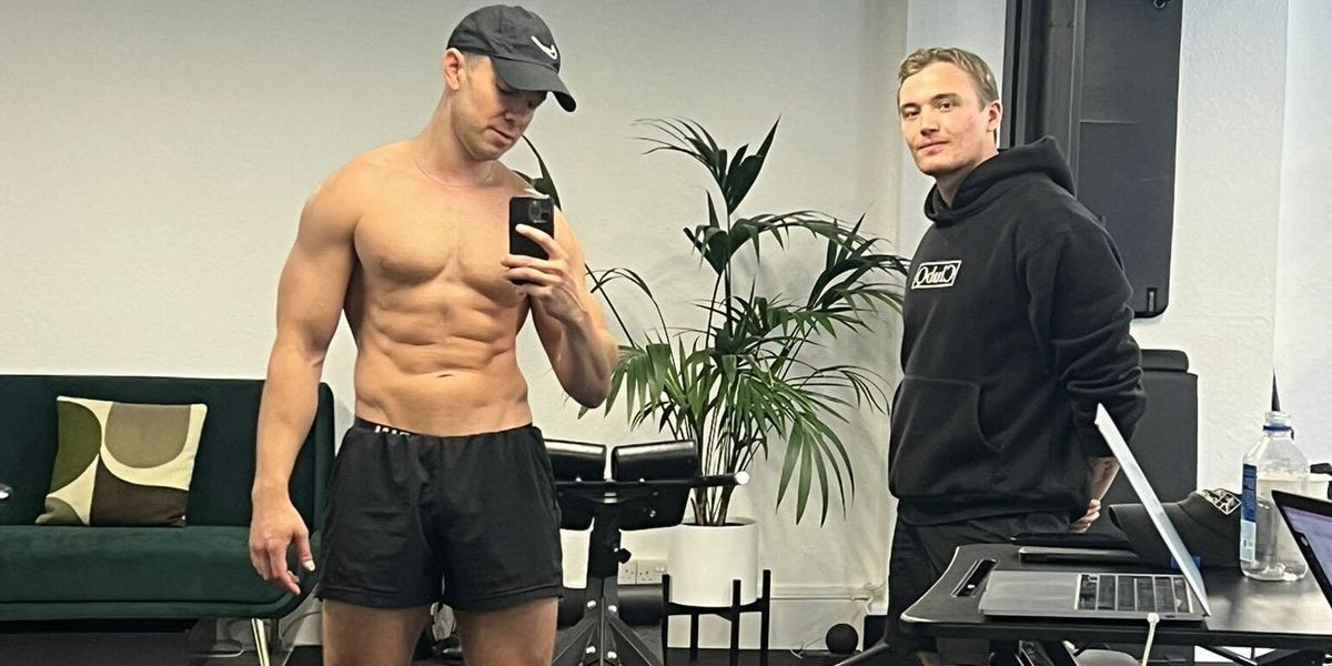 Man confidently walking in a city with a briefcase and a fitness tracker